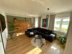 Charmanter Bungalow mit Wintergarten & ausbaufähigem Dachgeschoss | PV Anlage & Wallbox - Wohnzimmer.jpg